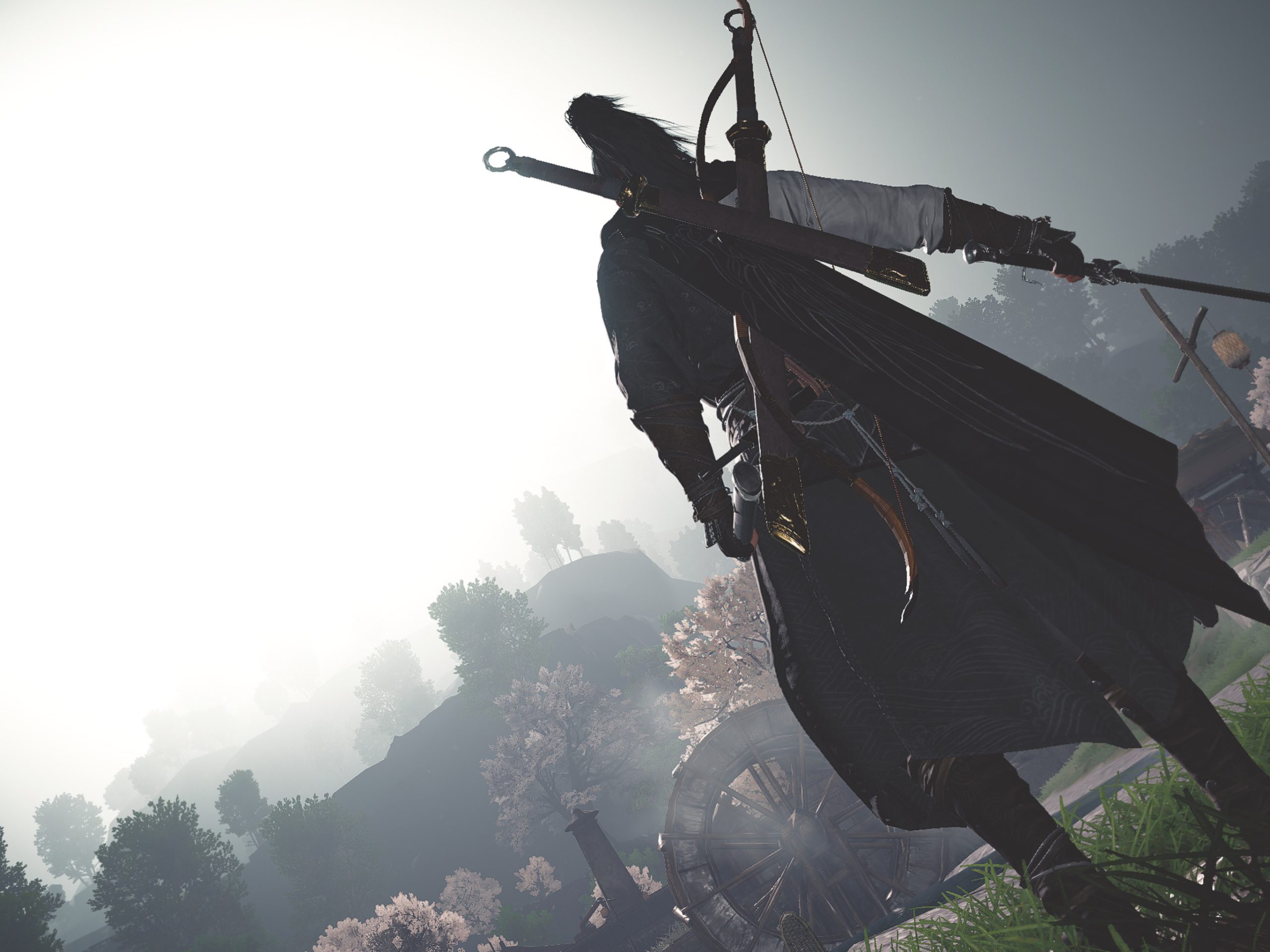 Game screenshot showing a wuxia character in the foreground, turning his back to the camera and holding a sword. Background is a beautiful landscape of hills and trees lost in the fog.